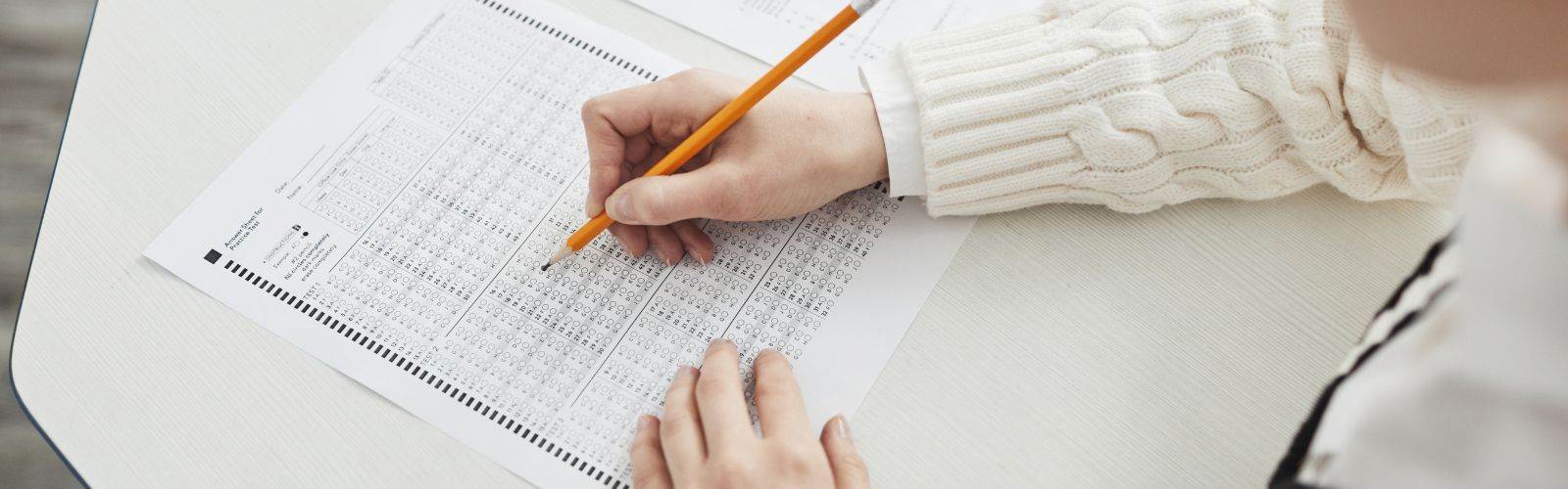 Student taking a test using a scantron and pencil
