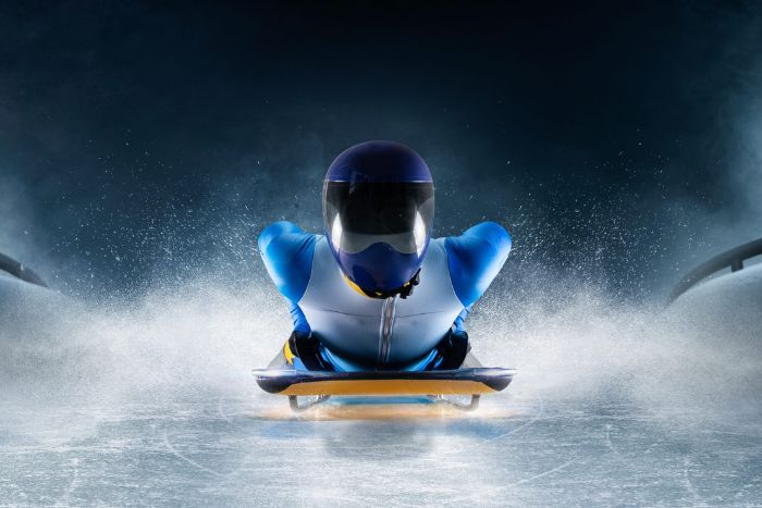 Skeleton racer on an ice track