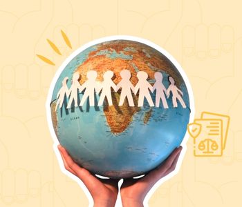 Human rights day collage image showing a hand holding a globe with paper cutouts of people with linked hands overlaid