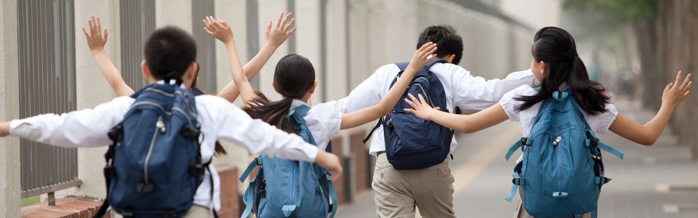 students running with backpacks