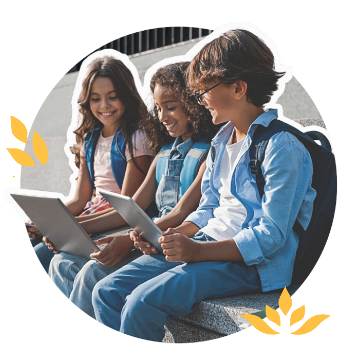 Three middle school students using computers and tablets outside